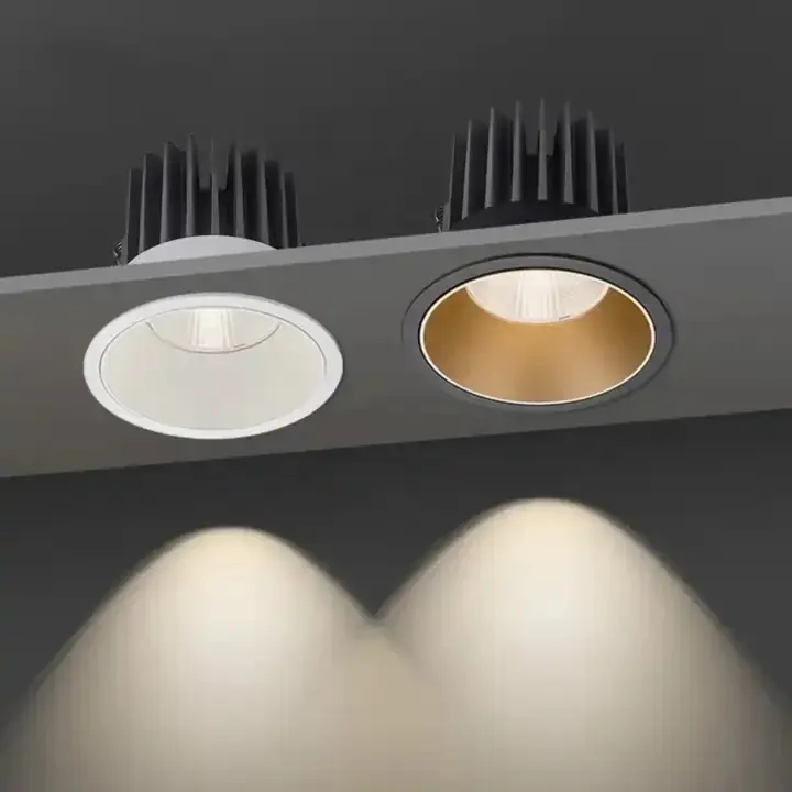 Two recessed LED downlights in black and gold trims, lit