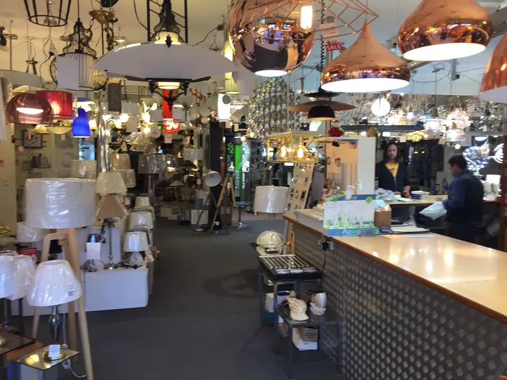 The showroom counter under a row of copper and black pendants