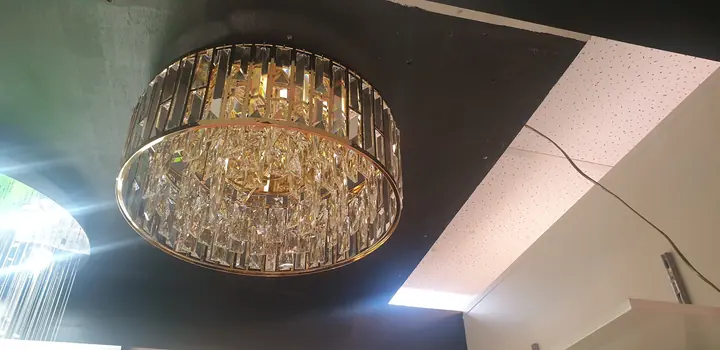 A crystal flush ceiling light lit in the Cosmo Lighting showroom