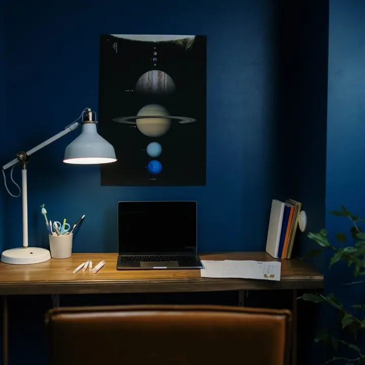 A desk lamp lighting a study desk at night