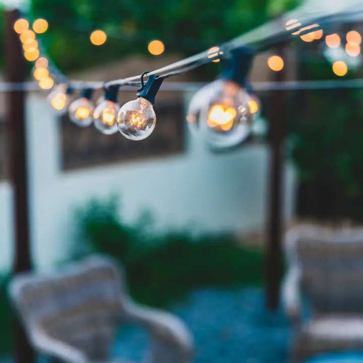 Festoon lights strung over an outdoor seating area