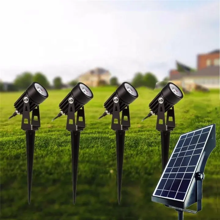 Solar-powered garden spot lights with a panel on a lawn